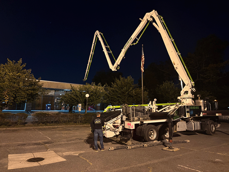 Concrete pumping Concrete pumping truck set up in front library parking lot.